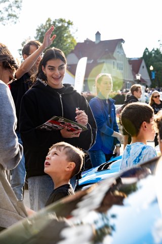 Toni Breidinger, driver of the #70 Nitro Motorsports Toyota GR86 Cup Car, stands by her car and greets fans during the annual parade of cars before Races 9 and 10 at Road America on August 17, 2023. -Photo by Zack Cramer
 | SRO Motorsports Group