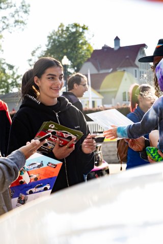 Toni Breidinger, driver of the #70 Nitro Motorsports Toyota GR86 Cup Car, stands by her car and greets fans during the annual parade of cars before Races 9 and 10 at Road America on August 17, 2023. -Photo by Zack Cramer
 | SRO Motorsports Group