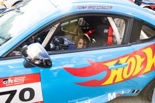 Toni Breidinger, driver of the #70 Nitro Motorsports Toyota GR86 Cup Car, stands by her car and greets fans during the annual parade of cars before Races 9 and 10 at Road America on August 17, 2023. -Photo by Zack Cramer
 | SRO Motorsports Group
