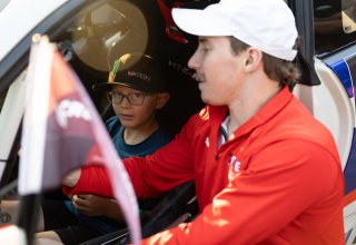 Spike Kohlbecker, driver of the #55 TechSport Racing Toyota GR86 Cup Car, stands by his car and greets fans during the annual parade of cars before Races 9 and 10 at Road America on August 17, 2023., -Photo by Zack Cramer
 | SRO Motorsports Group
