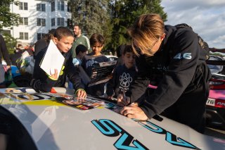 Lucas Weisenberg, driver of the #46 Lucas Racing Toyota GR86 Cup Car, greets fans during the annual parade of cars before Races 9 and 10 at Road America on August 17, 2023. -Photo by Zack Cramer
 | SRO Motorsports Group