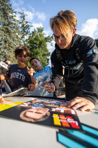 Lucas Weisenberg, driver of the #46 Lucas Racing Toyota GR86 Cup Car, greets fans during the annual parade of cars before Races 9 and 10 at Road America on August 17, 2023. -Photo by Zack Cramer
 | SRO Motorsports Group