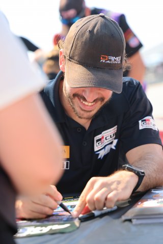 Justin Piscitell, driver of the #28 McCumbee McAleer Racing Toyota GR86 Cup Car, during an autograph session before Race 10 at Road America on August 20, 2023. -Photo by Dave Biro
 | SRO Motorsports Group