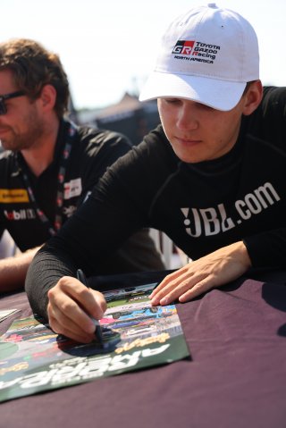 Corey Heim, driver of the #24 Nitro Motorsports Toyota GR86 Cup Car, during an autograph session before Race 10 at Road America on August 20, 2023. -Photo by Dave Biro
 | SRO Motorsports Group