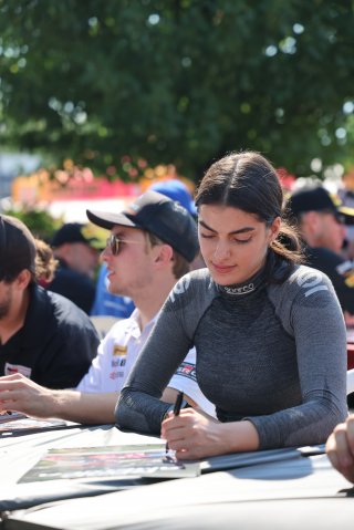 Toni Breidinger, driver of the #70 Nitro Motorsports Toyota GR86 Cup Car, during an autograph session before Race 10 at Road America on August 20, 2023. -Photo by Dave Biro
 | SRO Motorsports Group