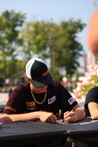 Tyler Gonzalez, driver of the #57 Copeland Motorsports Toyota GR86 Cup Car, during an autograph session before Race 10 at Road America on August 20, 2023. -Photo by Dave Biro
 | SRO Motorsports Group