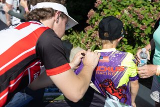 Spike Kohlbecker, driver of the #55 TechSport Racing Toyota GR86 Cup Car, during an autograph session before Race 10 at Road America on August 20, 2023. -Photo by Zack Cramer
 | TGRNA               