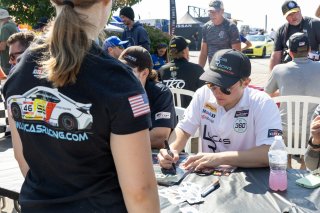 Lucas Weisenberg, driver of the #46 Lucas Racing Toyota GR86 Cup Car, signs autographs before Race 10 at Road America on August 20, 2023. -Photo by Zack Cramer
 | TGRNA               